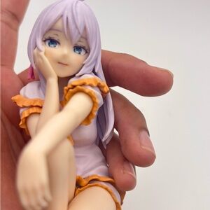 Anime Character Figurine with Purple Hair and Orange Accents